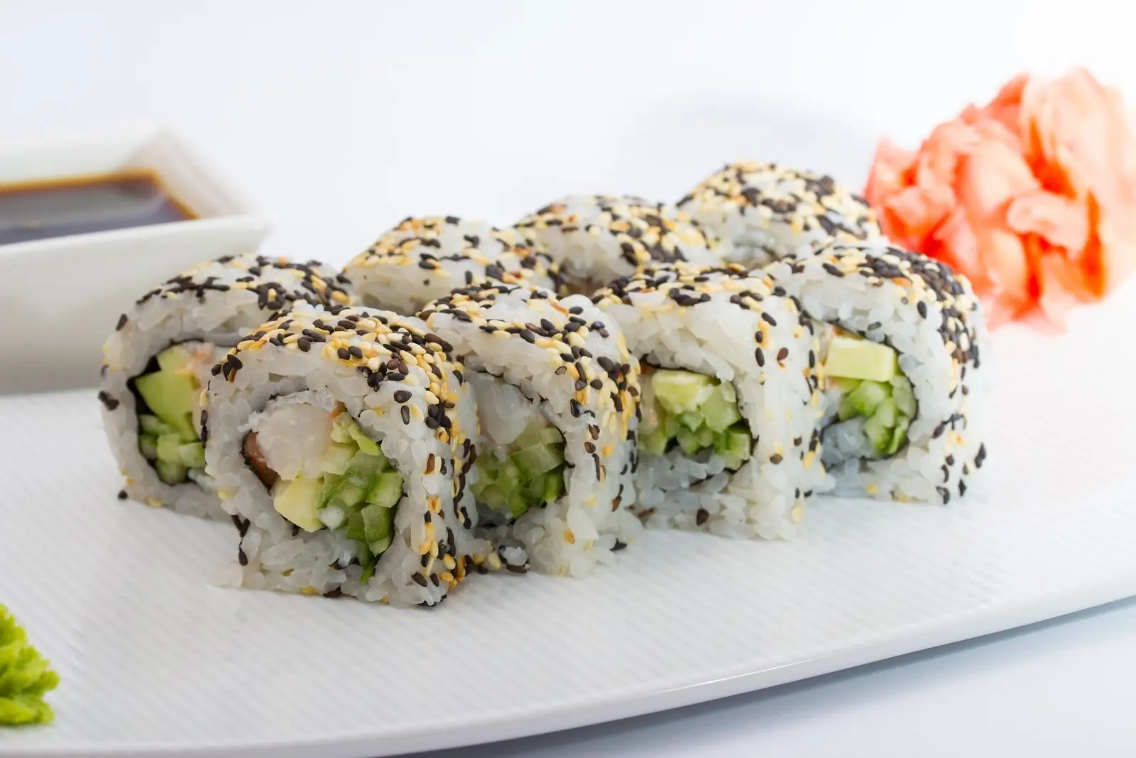 Sushi roll topped with sesame seeds, filled with shrimp and veggies at Mr Cao Japanese Steakhouse in Hutchinson