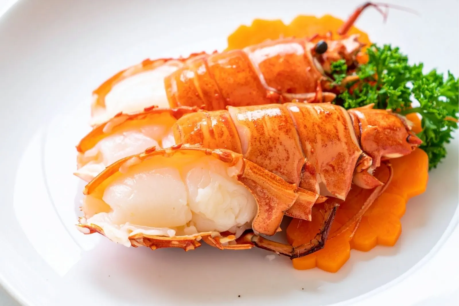 Tender grilled lobster tails served with garnish at Mr Cao Japanese Steakhouse in Hutchinson